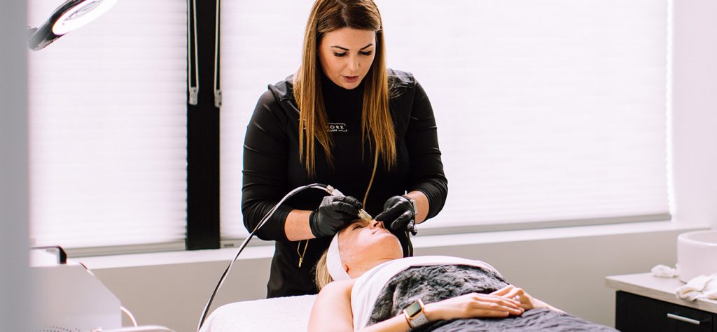 Staff member performing laser skin treatment