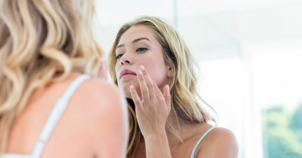 A woman maintaining optimal skin health after reading Dr. Rockmore's blog.