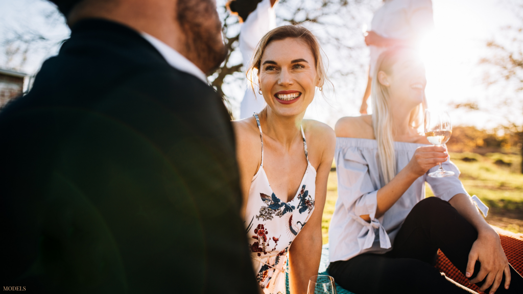 Woman socializing with friends after having a facelift in Latham, NY.