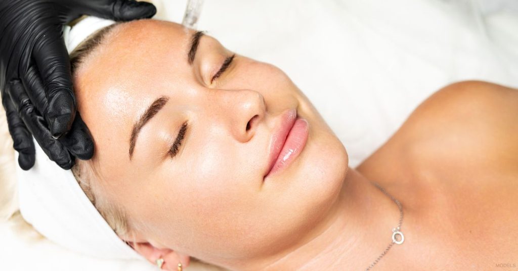 A woman getting a facial treatment at a med spa. (Models)