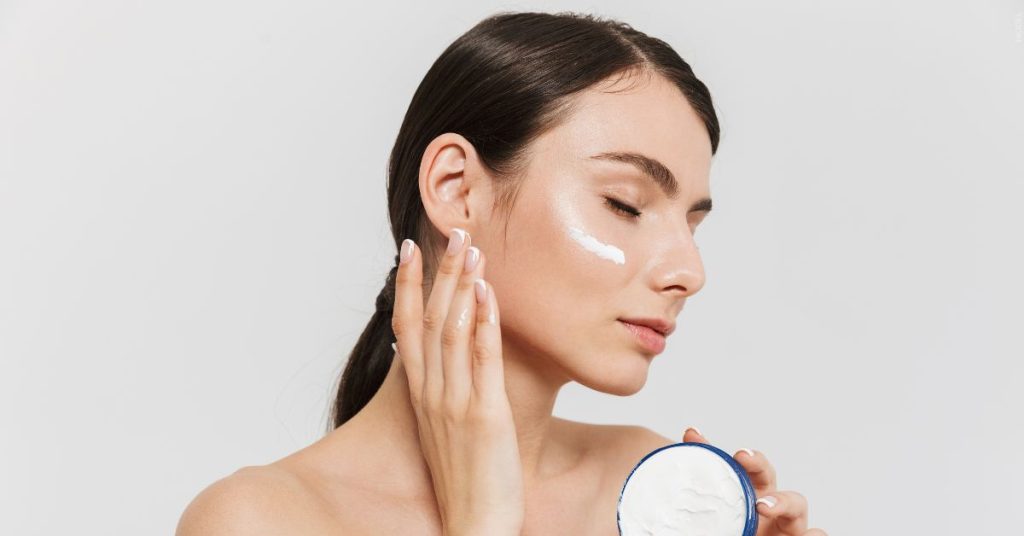 Woman applying skincare (model)